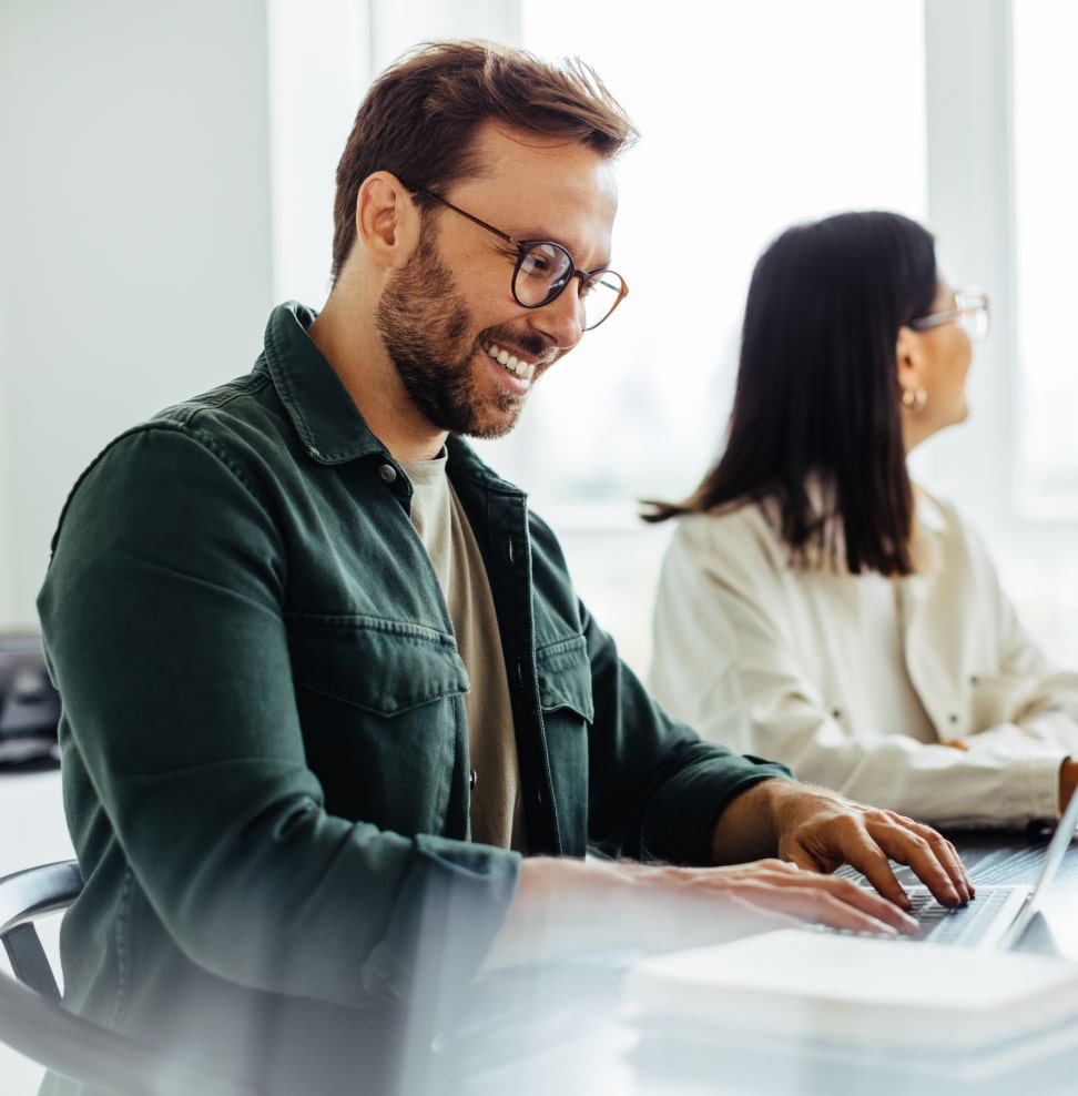 finance-img-min 2 ladies seated at an office table going over data on a laptop