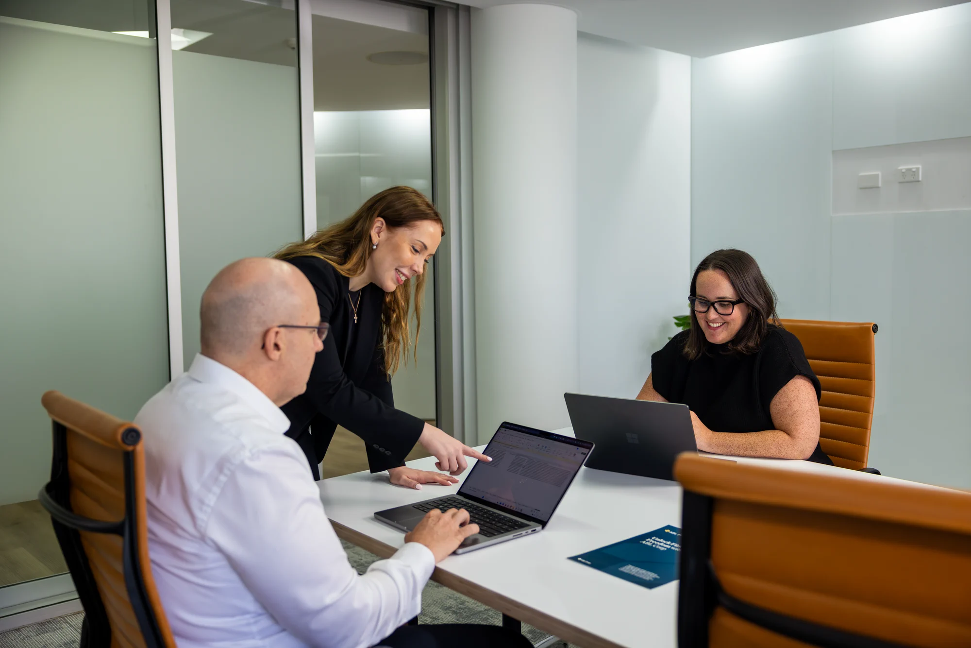 IMG_1199_converted man seated at an office desk working on a laptop